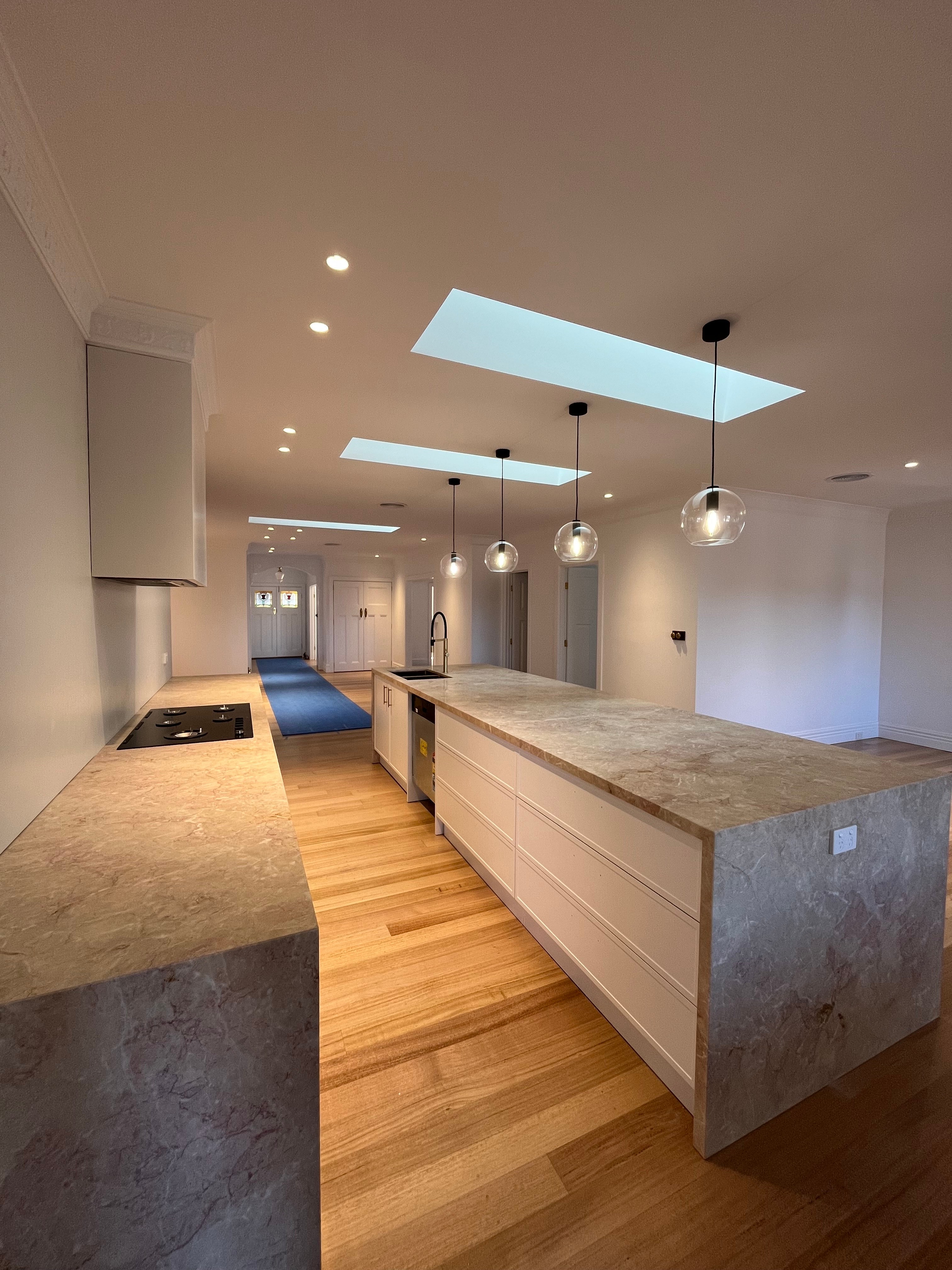 A render of three white cylindrical columns, against a warm creme background